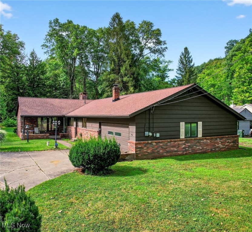 Peaceful Riverfront Retreat in Russell Township. Tucked away on a quiet dead-end street in the heart of Russell Township, this charming brick ranch offers the perfect blend of privacy, comfort, and timeless appeal. Built in 1962, it rests on a picturesque 1.3-acre lot along the tranquil Chagrin River, showcasing beautiful riverfront views and a serene natural setting. Inside, the home offers 1,775 square feet of thoughtfully designed living space, including three inviting bedrooms, one full bath, and one half bath. The warm and welcoming interior features a cozy fireplace, a built-in bar, and an abundance of windows that frame views of the yard and river while filling the home with natural light. Doors lead to a peaceful patio, perfect for enjoying the sights and sounds of nature year-round. This well-maintained home has been thoughtfully updated with a furnace and central air replaced in 2019, a hot water tank installed in 2024, a well pump updated in 2021, a roof replaced in 2020, and new gutters added in 2023. The septic system has also been recently serviced and cleaned, providing added peace of mind. A spacious two-and-a-half-car garage includes a rear workroom ideal for hobbyists, projects, or extra storage. Offering peaceful seclusion yet conveniently located near local amenities, this property presents a rare opportunity to own a slice of nature in one of Geauga County’s most sought-after areas.