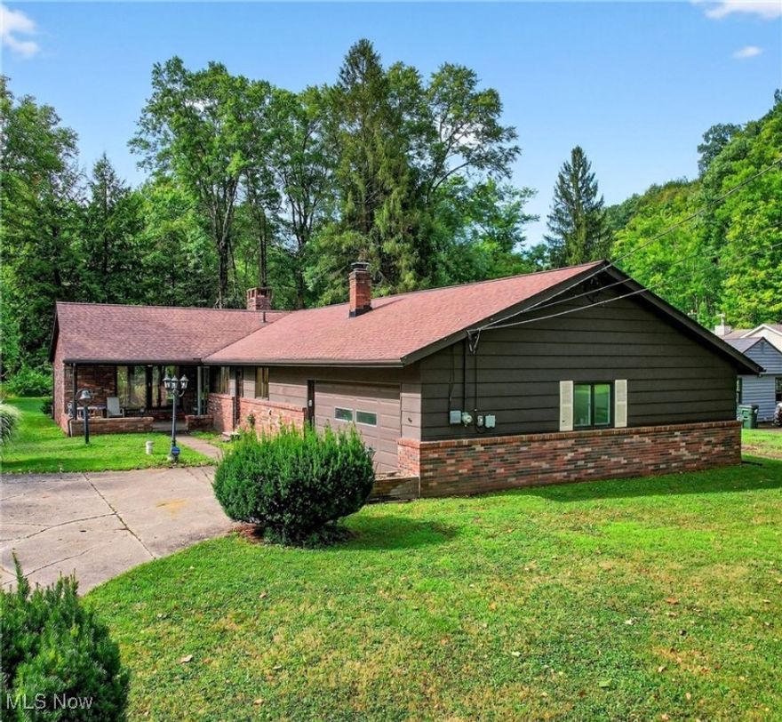 Peaceful Riverfront Retreat in Russell Township. Tucked away on a quiet dead-end street in the heart of Russell Township, this charming brick ranch offers the perfect blend of privacy, comfort, and timeless appeal. Built in 1962, it rests on a picturesque 1.3-acre lot along the tranquil Chagrin River, showcasing beautiful riverfront views and a serene natural setting. Inside, the home offers 1,775 square feet of thoughtfully designed living space, including three inviting bedrooms, one full bath, and one half bath. The warm and welcoming interior features a cozy fireplace, a built-in bar, and an abundance of windows that frame views of the yard and river while filling the home with natural light. Doors lead to a peaceful patio, perfect for enjoying the sights and sounds of nature year-round. This well-maintained home has been thoughtfully updated with a furnace and central air replaced in 2019, a hot water tank installed in 2024, a well pump updated in 2021, a roof replaced in 2020, and new gutters added in 2023. The septic system has also been recently serviced and cleaned, providing added peace of mind. A spacious two-and-a-half-car garage includes a rear workroom ideal for hobbyists, projects, or extra storage. Offering peaceful seclusion yet conveniently located near local amenities, this property presents a rare opportunity to own a slice of nature in one of Geauga County’s most sought-after areas.