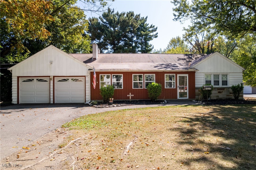 Nestled on 1.66 acres, this charming ranch home offers space, character, and endless potential. Step inside to find an enclosed front porch that welcomes you into a comfortable main level featuring three bedrooms, a spacious living room, a dining room, and a bright, cheerful kitchen. A huge walk-up attic invites your imagination with the possibility of being finished into a cozy retreat, home office, or additional living space. The finished basement extends your living area even further, offering two recreation rooms including one with a bar, a versatile bedroom option, a storage room, and a dedicated laundry area, all accented by classic glass block windows. Outside, the appeal continues with a long driveway leading to a two-car attached garage, a convenient sidewalk along the side of the garage, and beautifully maintained landscaping. The fully fenced backyard is perfect for relaxing, entertaining, or play, and the property itself extends well beyond the fence, providing even more room to enjoy. Currently used as a single-family residence under a nonconforming use allowance, the property is zoned General Retail Business, creating unique opportunities for its next owner.