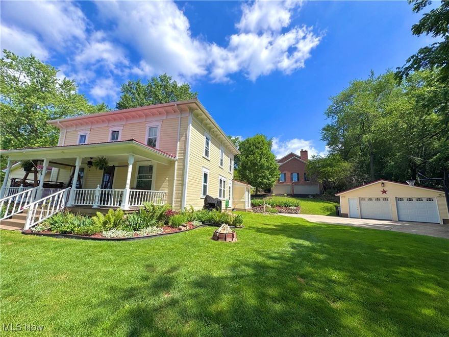 Welcome to the stunning views and timeless beauty only 309 Donahey NE  can offer.  This original New Phila homestead started it all, having a classic charm that cannot be replicated.  Nestled amongst the trees, on over half an acre, above beautiful Donahey Ave and Darrell Dr, Tuscora Park is just a short walk away.  Featuring 4 bedrooms, 2 full baths, large living room with a stone, wood-burning fireplace, there’s plenty of places to explore.  Gorgeous hardwood floors, many rooms with original trim, hand-built nooks, and creative spaces flow throughout this colonial.  Relax out on the picturesque front porch or head over to the newly updated private 12x24 space that could be used for a guest house, air bnb, office, or shop.  The 2 car, detached garage has 100 amp electric and includes a wood-burning stove.  House and guest space have 200 amp service.  Updates include 2025-kitchen stainless hood, master bath faucet, flooring & entry door sanded and refinished, 2021-2019-metal roof, cement drive expansion and additional 4 parking spaces, updated laundry room and master bath, landscaping & stonework, trees removed/maintained, flower beds added, stainless kitchen appliances, interior paint, and updated electric.  You absolutely must see this property!  Contact an agent for your personal tour!