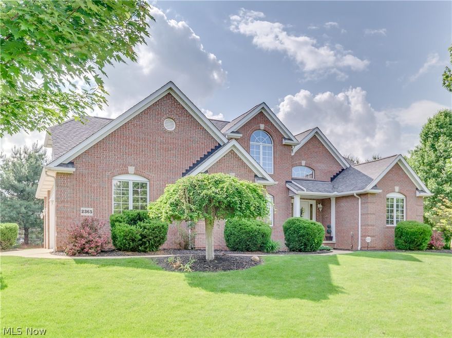 This brick colonial is in Saint James Place on a private corner lot. First floor master suite with large walk in closet, attached bath with double sinks and standing shower unit.  Office off of the front entrance with access to this bathroom as well.  Beautiful columns, and tray ceiling in the open dining room.  Cathedral ceiling, skylights, and extra large living room with a corner fireplace.   Cherry stained hickory woodwork throughout brings this classic charmer to life. The kitchen boosts a double oven and counter top range.  Raised breakfast bar area and eat in kitchen, The patio slider doors lead out to the enclosed porch with composite decking and windows that were installed in 2009.  Brick patio.    The finished lower level offers a section for a work out room and a fifth bedroom, in addition to the living spaces   Three bedrooms upstairs with plenty of closet space.  Beautiful sunburst windows.  First floor laundry and washer and dryer are included.   Plenty of space in this t
