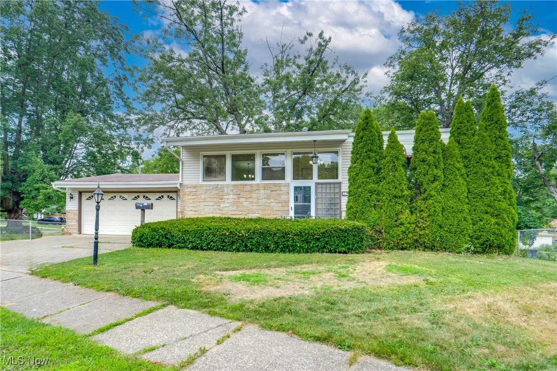 Welcome to 1508 Hyde Park Avenue, a beautifully remodeled home in North Akron offering modern updates, stylish finishes, and flexible living space. From the moment you step inside, you'll notice the stunning hardwood floors and natural light pouring through oversized windows, highlighting the open concept living room with vaulted ceilings and a sleek electric fireplace feature. The dining area flows effortlessly into the brand new kitchen, featuring granite countertops, stainless steel appliances, and modern cabinetry, perfect for both everyday meals and entertaining. Two generously sized bedrooms and a fully renovated tile bathroom complete the main floor. Downstairs, the finished lower level adds incredible versatility with two additional bedrooms, another full floor to ceiling tiled bathroom, and walkout access to the fully fenced backyard. There’s also plenty of unfinished basement space for storage, laundry, or future expansion.The attached two car garage provides convenient parking and storage. Every inch of this home has been thoughtfully updated. Just move in and enjoy!