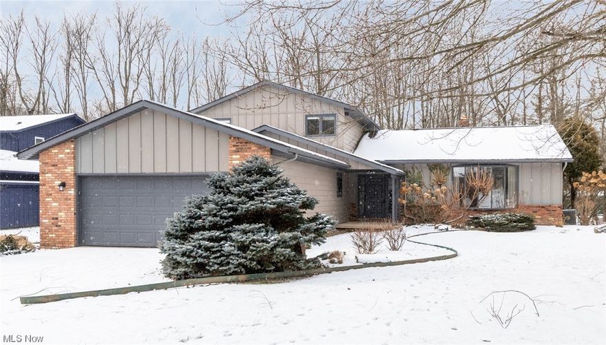 Orangewood Split-level is ready to move-in! Freshly painted throughout, the neutral decor works seamlessly with all of the upgrades in this home! Entry foyer with hardwood opens with steps up to the large living room with hardwood, recessed lights and bowed picture window. Dining room is in "L" shape for ease of entertaining, including built-in cabinetry with granite serving bar! Eat-in kitchen with island and dining area is perfect for the home chef, and offers updated cabinetry, JennAir cooktop, double ovens, ceramic tile floor, and a custom roll-out pantry! Step down to the family room with wood floors, wet bar, and built-in storage with brick feature wall and gas fireplace for chilly evenings at home! Newer sliding doors open to the multi-level redwood deck and paver patio, great for outdoor dining and activities in private, wooded setting. Back hallway with wood floors leads to spacious Master suite with incredible array of built-in drawers and shelves, a walk-in closet with organizing system, and full bath with stall shower. Convenient laundry and powder room also off back hall with access to the two car plus garage. Second floor has a large hall with walk-in closet with organizer, and three spacious bedrooms. Recently re-done full bath in hall has double vanity and oversized step-in stall shower. Carpeted basement has 2 large, clean crawl spaces for additional storage. 50 gallon hot water tank is 4 years old. Electrical includes 200 amp service. Electronic dual zone HVAC has automatic damper control for efficient heating and cooling! HSA Home Warranty included. Don't let this one get away!!