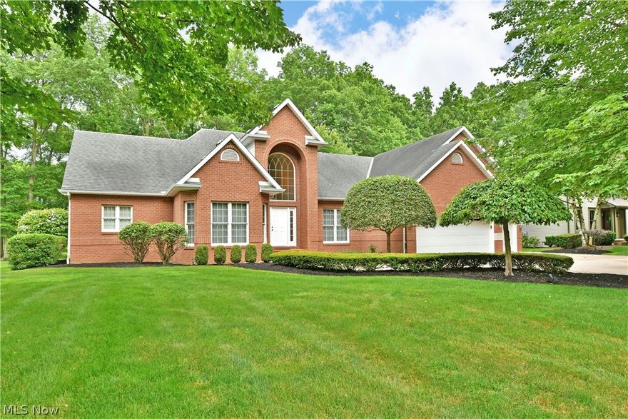 Commanding your attention from every angle, this prominent custom built brick-faced estate is a hidden Howland treasure! Quietly tucked away in a highly desirable neighborhood that overlooks the old Avalon golf course, this resounding home is truly one to behold. Expertly crafted landscaping outlines the cement drive, widening at the apron to receive a three-car garage. The oversized brick sidewalk continues up to the towering entryway where an arched window showcases the gleaming chandelier that hangs above the grand foyer. Bright, tiled flooring spills away underfoot as sunlight cascades down across the winding staircase. A home office easily converts to an additional bedroom, tying directly to a full bath. Across the hall, a lavish dining room sits under a sculpted tray ceiling. The illustrious living room is showcased with lush, cream carpets and tall windows providing golf course views. A marble wrapped fireplace divides the custom cabinetry at each side. Continuing down the impressive hall, an expansive kitchen opens with tall ceilings and window wrapped dining space. The sweeping countertop looks on towards the nearby family room and its second fireplace. First floor laundry and half bath are located near garage access. Completing the floor, an oversized master suite hosts a huge walk-in closet and elaborate bath with jacuzzi tub. Upstairs opens to a a landing overlooking the gracious foyer below. There are three over sized bedrooms that offer an additional two full baths one is shared between the two and the other is a full bath off of the 3rd bedroom. The back yard is the gem with views of the golf course through huge banks of windows or from the private patio. Call today for more!