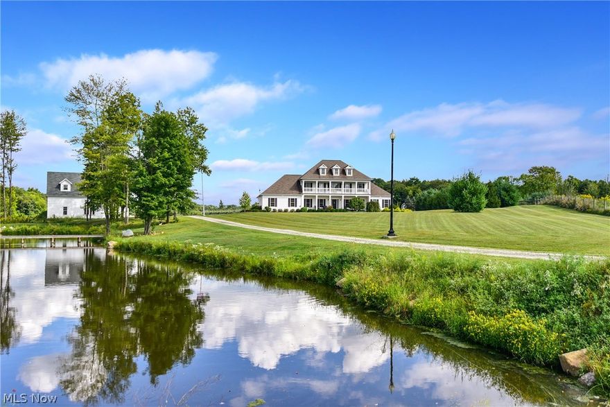 Absolutely STUNNING 5 Bedroom Georgian Colonial Estate/Horse Farm sits on 25+ Acres PLUS 5 Stall Horse Barn & Huge Outbuilding with Loft.  First Floor:  Home Features Include:  Large Back Great Room with Wood Burning Fireplace, SPECTACULAR Gourmet Kitchen with Granite Counter Tops, Stainless Steel Appliances, and Center Island, HUGE Movie Theater Room/Game Room, Formal Dining Room, First Floor Master Bedroom with Master Bath & Large Walk In Closet, and AMAZING First Floor Laundry Room/Butlers Pantry.  Second Floor Offers a SECOND Master Bedroom with Master Bath & Walk In Closet, plus 3 other Large Bedrooms and 2 more Full Baths.  The Second Level has access from the Front Bedrooms to a Spacious 8 x 54 Open Air Plantation Deck made from maintenance free TREX.  GEOTHERMAL HEAT for super heating & cooling efficiency.  The Back Sun Room leads to an AMAZINGLY Private Scenic Backyard with Pastures & Wooded View.  The Stocked Swimming Lake comes with a Dock & ZIP Line.   There are 15 acres of