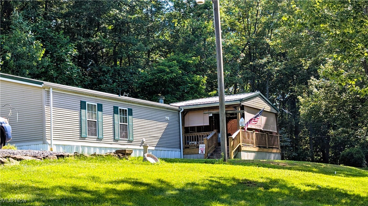 Escape to your own private sanctuary at 99 Chestnut Lane, a charming homestead offering the perfect blend of rustic tranquility and convenient living. Situated on a sprawling 7.52-acre lot, this property is a true hidden oasis, directly across from the picturesque Tomlinson Run State Park.
Whether you're seeking a place to get off the grid, a hunting lodge, or a perfect family retreat, this property delivers. The cozy, one-story manufactured home features 1,216 square feet of comfortable living space, including 3 spacious bedrooms and 2 full bathrooms. The heart of the home is a welcoming living room with a factory-built wood-burning fireplace, perfect for gathering with loved ones on a chilly evening. This situation is perfect for immediate housing with the options to build your dream home when you are ready.
Step outside to discover the true potential of this expansive property. Enjoy your morning coffee on the covered front porch or host a summer barbecue on the private deck. The land is a blank canvas for your dreams, whether you envision a garden, a small farm, or simply a private, wooded playground.
A standout feature is the huge, detached four-car garage with a cement floor, providing ample space for vehicles, a workshop, or even converting it into a barn for horses or other livestock.
With no HOA restrictions, this property offers you the freedom to live life on your terms. And while it feels a world away, it's just a 15-minute drive from local grocery stores, gas stations, and other amenities. Enjoy a lifestyle of adventure with hiking, fishing, and boating at your doorstep, all while having the privacy and space you've always dreamed of.
Don't miss this opportunity to own a piece of West Virginia paradise. Your secluded homestead awaits.