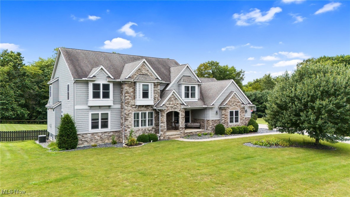This 5-bedroom colonial sits on a 2.07-acre wooded lot with a fenced backyard, two-tiered deck, and covered composite porch. The main floor includes hardwood floors in the foyer and dining room, a first-floor office with French doors and plantation shutters, and a front room that can be used as a music room, playroom, or formal sitting area. The great room has a gas fireplace with updated tile and mantle, built-in cabinets, wood floors, skylights, and transom windows. The eat-in kitchen features quartz countertops, stainless steel appliances, a wall of pantry cabinets, and a center island with breakfast bar. A large mudroom with utility sink and backyard access completes the first floor.
Twin staircases lead upstairs, where you’ll find a laundry room with maple cabinets, a full bath with dual entry and double vanity, and the owners’ suite with double-door entry, walk-in closet, and an updated bath with new shower surround, faucets, double vanity, heat lamp, and large linen closet.
The finished basement offers a full bath, stone-front bar, projector and screen, surround sound, and storage.
Recent updates include: tankless water heater (2024), added basement bath, new fenced backyard, expanded deck with pergola, hardwood flooring on first floor, updated bathrooms, new carpet, and interior painting. A detailed list is available.
Appliances included: kitchen appliances, washer/dryer, basement bar, surround sound system, projector and screen.
Located near shopping and dining in Medina, outdoor recreation at Hubbard Valley Park and Chippewa Lake, with easy access to I-71 and I-76 for commutes to Akron, Cleveland, and surrounding areas.