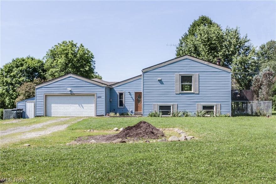 This beautiful home in the countryside of Randolph Township has so much room for the price with over 2,300 sf of living space and 2.55 acres of land! Three, possible four bedrooms, 1.5 baths, ceramic tile foyer, sprawling great room with wood burning stove overlooking the open back yard. Nicely updated bathrooms, and kitchen with stainless steel appliance package! The family room / combined dining room off of the kitchen make for a nice open upper level floor plan. Walk out to the second-level deck, which offers views of over 2 .5 acres of land. Dry basement with finished rec. room and additional room, which could be fourth bed/office/hobby. The two-car attached garage and its additional storage provides a safe place to keep your vehicles and outdoor supplies. Newer chain link fenced in backyard. Waterloo schools, or open enroll to Field or Rootstown Schools. Newer siding and windows. Located 30 minutes from the Akron-Canton Airport. Quick access to I-76: Akron, Youngstown, and Canton.