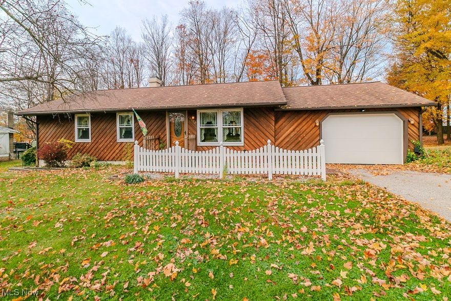 Welcome to this cozy ranch on a lovely wooded lot in Burton Village. Lovingly cared for with gleaming parquet wood floors through main living space & bedrooms. The eatin kitchen has laminate floors, updated oak cabinetry, corian counters & all appliances. A full bath w/ tub shower & 3 bedrooms complete the main floor. The lower level has a recreation room w/ paneling & ceramic tile,  with a wood burner & half bath. The laundry/ mechanical area has ceramic tile. The private yard has a nice deck with a lovely gazebo perfect for watching the birds. Full house generator. Ready for a new owner! Come home to the Pancake Capital with all Burton Village has to offer.