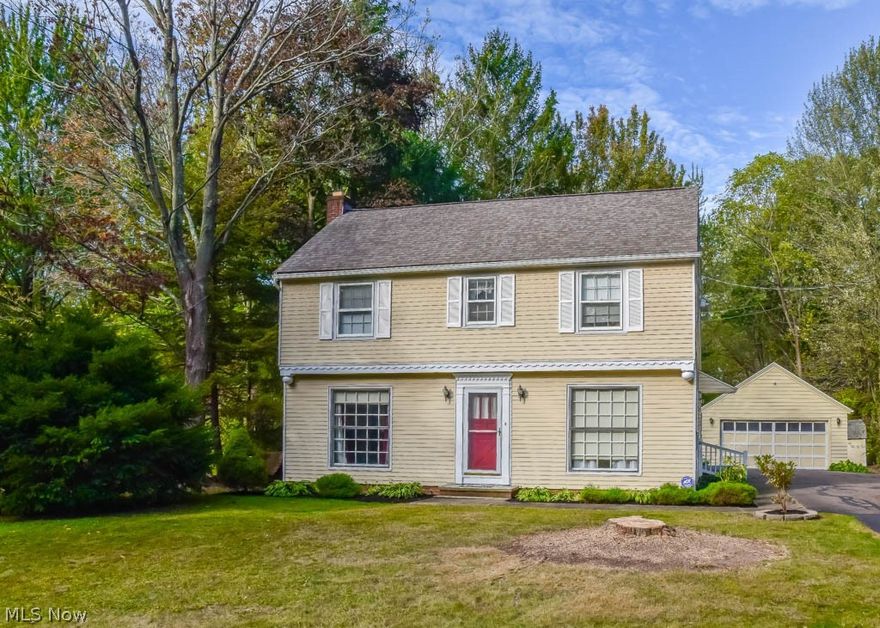 Lovingly maintained 3 bedroom, 1.5 bath colonial on 2 lots! New, neutral colored carpet throughout! Crack open your cookbook in the eat-in kitchen with newer countertops and flooring. Enjoy a casual meal in the dinette or host holiday gatherings in the formal dining room with wainscoting. The spacious living room boasts a picture window and a gorgeous fireplace to keep you warm all winter! Half bath just around the corner, too. Lots of character with arched doorways and crown molding. Upstairs, there are 3 bedrooms, hallway built-ins and a full bath. The master bedroom is huge and offers 2 closets. There’s also walk-up access to the attic - super convenient for storage or finish for extra living space. The lower level also offers incredible storage, glass block windows and finishing potential. The 2-car detached garage includes a covered back porch plus an 11x10 room that would make a fantastic play house or workshop! Super deep backyard with a shed, cleared areas to play and wooded ar