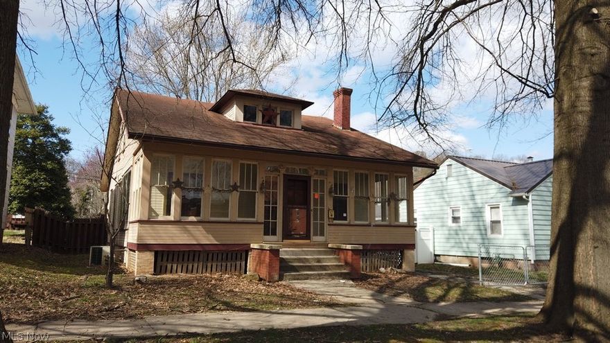 This bungalow on Oakwood Avenue is one to see. If ever there was a home that deserved love and attention, this is one!. Features two fire places surrounded by book cases and cabinetry. Glass doors take you out onto the enclosed front porch and sliding doors between the dining and living rooms.