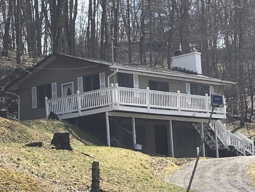 This is a rare opportunity to own your own turnkey cabin perched above Piedmont Lake! Outdoor enthusiasts will love this fully updated, modern, and charming getaway cabin. The yellow pine walls and ceilings and brick wood burning fireplace in the main living area bring warmth and rustic charm to this lakeside retreat. This home boasts two spacious bedrooms (both with a large walk-in closet), a modern bath, an inviting living room, an eat-in kitchen (with granite countertops), and a large deck and detached garage, all sitting on five lots (nearly an acre of privately owned, not leased, land). All this is within easy walking distance to the lake. The dues and the fee for the nearby Edgewater Park Docking Association are paid for 2022, but if the new owner is interested in docking a boat, there is a separate fee (approximately $200/year) payable to Muskingum Watershed Conservancy District for overnight docking. This cabin comes mostly furnished plus with all appliances and a generator. An