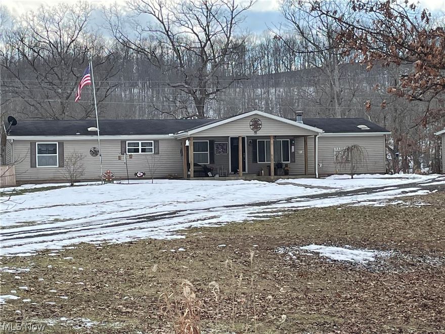 If you are looking for a newly updated, spacious home, you have found it and its waiting for you. This home has so much to offer.  A 2000 Manufactured home that sets on a permanent foundation and has been converted to real estate. Home has 3 bedrooms, and 2 baths.  Kitchen/dining and Living area have the open concept feel as soon as you walk in.  The German Schmear fireplace sets the stage for coziness as soon as you walk in the living room from the front door. The master bedroom and bathroom is just beautiful, with a sliding barn door separating the two.  Home also had new Central AC installed last summer, 2021. Outback is a new 24 ft. round above ground swimming pool with a new deck to enjoy poolside on those nice summery days, not to mention an approximate 12x30 patio leading up to the deck. 2 Car, detached garage is heated, has a concrete floor, hot and cold water, and to top if off, a 12x16 foot walk in cooler. Newer landscaping/curb appeal put in just last summer to adorn the walkways and patios not to mention some woods with wildlife to entertain you as well.  There is also a barn/outbuilding to store all your seasonal toys.  This home has everything you need, don't wait, it won't last long, call today to schedule a viewing. The 10x20 Brand-new storage shed will not convey, but can be purchased separately.