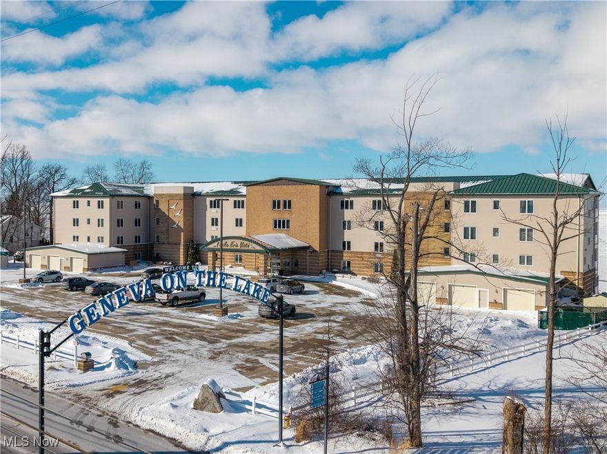 Highly sought after condo in Geneva-on-the-Lake, directly on the shores of Lake Erie. This meticulously maintained 2 bed, 2 full bath unit is perfect for your vacation retreat or investment opportunity! This stunning unit features a bright open concept, where every view from the kitchen, dining area, and living room showcases breathtaking lake views and beautiful sunsets. Step onto your private balcony and enjoy peaceful mornings and evenings overlooking the water. The kitchen offers white cabinetry, granite countertops, stainless steel appliances, custom tile backsplash, under cabinet lighting, breakfast bar, new dishwasher, and a new disposal. The kitchen flows seamlessly into the dining and living areas making entertaining a breeze. Hardwood flooring runs throughout the entire condo adding warmth and elegance. The spacious primary bedroom features tray ceilings with custom LED lighting and crown molding, creating an elegant retreat. Distinctive features include spacious walk-in closet and private ensuite bathroom featuring granite countertops, custom tiled walk-in shower, rain-style shower head and soothing body jets. Second bathroom offers granite countertops and a relaxing jetted tub. In-suite laundry completes this unit for everyday convenience. The on site amenities include a well maintained heated indoor pool, private owners’ gym, gathering room, storage area, and common areas on each floor. No need to take the stairs when the building is serviced by dual elevators. Owners and guests enjoy a concrete pier, private beach, fire pits, BBQ grills, and picnic areas overlooking Lake Erie. Located just minutes from the Geneva-on-the-Lake strip, Geneva State Park, local wineries, dining, entertainment, the famous Ashtabula Harbor, and taxi service directly across the street. Whether you are seeking a peaceful getaway or a smart investment, this move in ready lakefront condo offers unforgettable views and a lifestyle you will love! Schedule your showing today.