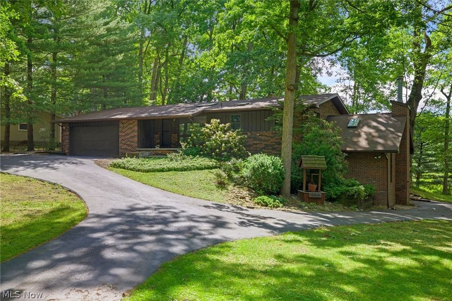 Welcome to this charming 1972 ranch-style home located in a quiet residential neighborhood on Grape Lake. Step inside and be welcomed by the open floor plan that allows the living room, dining area, and kitchen to flow seamlessly together. The large windows and skylights give this area a bright open feel while the brick accent wall with a fireplace adds a cozy touch to the living room. The kitchen comes equipped with a skylight, stainless steel appliances, a brick backsplash, and a wood cabinets. The 2 bedrooms both have neutral-colored walls, spacious closets, and windows that look out onto the woodsy terrain. The shared full bathroom on the main floor has an extra long single sink vanity, shower/tub combo, built-in linen closet, and an additional area to sit and get ready in the morning. Downstairs is the fully finished walk-out basement. This area boasts high vaulted ceilings with skylight windows, a floor-to-ceiling wood burning stone fireplace, and a bar area. On this level, you can also find a bonus room, a full bathroom with tiled flooring and a large walk-in shower, additional storage, and a second laundry area. This area is the perfect entertainment space for hosting friends and family! Outback you can find the attached wood deck that overlooks the expansive backyard and lake . The backyard is ideal for children and pets to run around and play. The home has an attached 2-car garage and a large U-shaped driveway with one side that extends down the right side of the home for additional outdoor parking. Don't miss out on this opportunity and schedule your private showing today!
