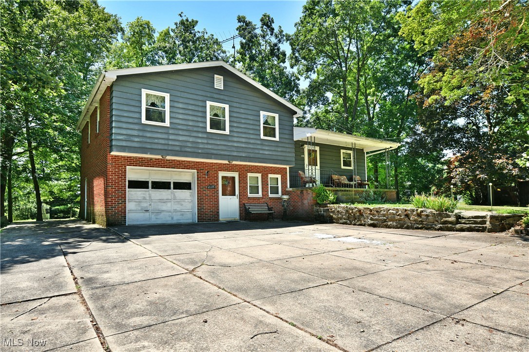 Step out of your comfort zone and into the countryside as you curate your own personal
getaway with this potential-packed Canfield estate! Don’t worry, you’ll still be just minutes
away from your favorite places like White House Farms where you can grab fresh produce
and morning donut; or raise your own inside the fenced-in backyard garden. There’s much
to explore here as the two-acre property packs in a ton. A personal pond to enjoy wildlife or
fish, a massive external garage for all your vehicle storage, workshop or clubhouse needs.
Three additional outbuilding follow suit plus a backyard outhouse for extra décor or a quick
trip as needed while tending the garden. The home itself sits far off the street at the end of
a winding cement driveway with an extra wide apron for easy turn around access. Rising
steps lead to a covered front porch and main entrance. The tiled foyer provides ample
closet space before opening to the central living room. Here, a brick fireplace is
surrounded by stained wood casework. Around the corner, a delightful kitchen provides
bar top dining space with its wrapping layout. Meanwhile, a rear sunroom steps down for
four season relaxation and easy entertaining. On the second floor, a trio of bedrooms are
joined by a deep-set full bath and its dual vanity. Downstairs, a wood panel family room
has corner provisions for a second fireplace as a half bath awaits the opposite side of the
room. Laundry services and utilities are located at the basement level. Call today for your private showing!