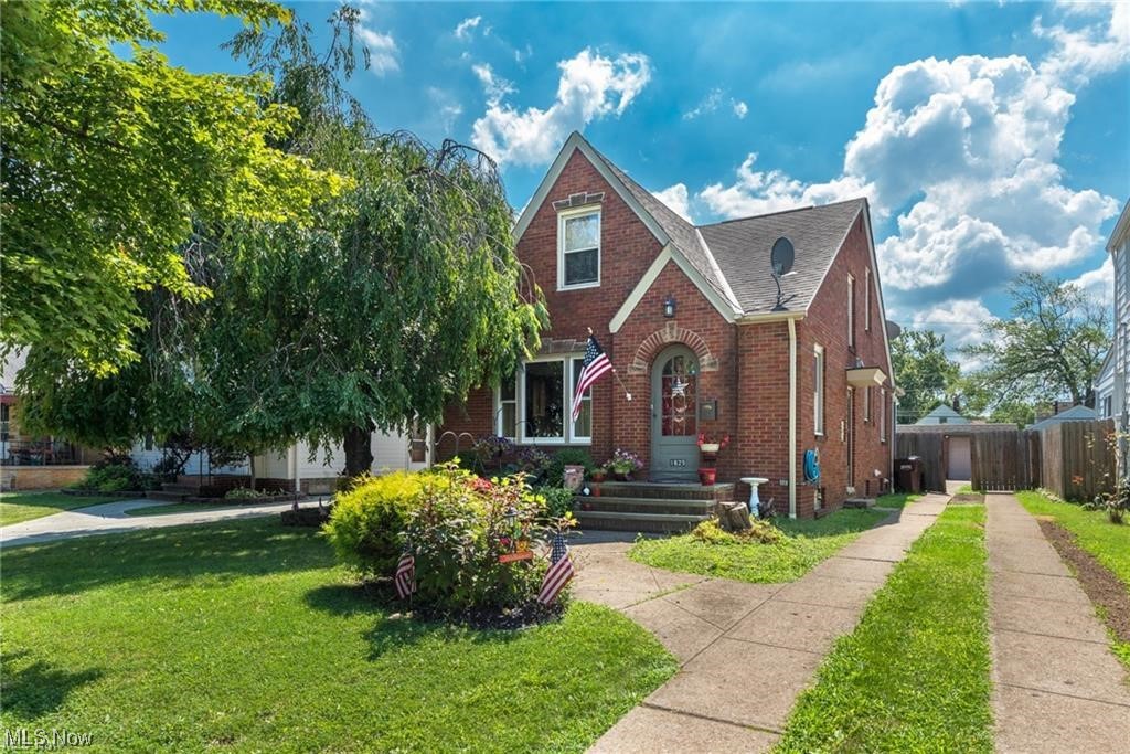 This charming 1947 Cape Cod features 4 beds, 2 full baths, and ample living space. The all brick exterior, arched front entryway, and steep roof peaks make an inviting first impression. Beautiful, original hardwood floors welcome you into the spacious main living room with arched doorways that lead you to the kitchen. The sizable kitchen features stainless steel appliances and tons of cabinet storage. The kitchen space is directly attached to a dedicated dining area. French doors open up to a wonderful enclosed sunroom with exposed brick and seamless entertainment to a private stamped patio. The first floor bedroom is placed down the hallway with the recently updated full bathroom. Additional 3 bedrooms are located on the second floor. The basement includes an extra 550 SF of living space with an awesome built-in bar, laundry room, and large secondary full bathroom, which has also been fully updated. Other features include a privacy fence, detached 2-car garage, and a deep backyard. Be