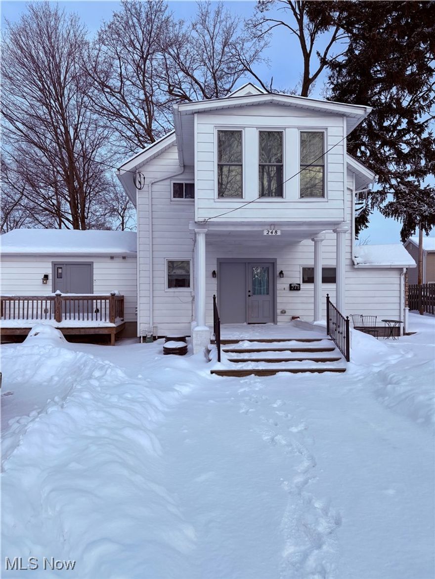 Welcome to this beautiful home in Painesville, where classic charm meets modern design. Step through the front door into a stunning, updated kitchen that flows seamlessly into a wide-open floor plan. The kitchen features brand-new white shaker cabinetry, granite countertops, and a spacious center island—perfect for gathering with friends and family. Just beyond the kitchen, you’ll find an expansive living room highlighted by a wood-burning fireplace and custom built-in cabinetry. A convenient first floor half bath is located just off the living area. The primary suite offers a private full bathroom and direct access to a perfect size deck, an ideal spot to enjoy your morning coffee. Upstairs, two oversized bedrooms showcase unique vaulted ceilings, along with two full bathrooms and a second-floor laundry room for added convenience. The fourth bedroom, located above the porch, is filled with natural light from its large windows. Truly one of a kind, this exceptional home offers space, style, and thoughtful updates throughout. All Appliances Included! Brand new carpet in living area. This home is ready for its new owners!!!!!