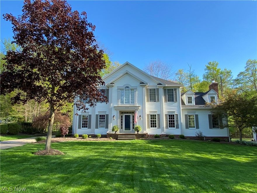 This immaculate Ashbrooke colonial greets you from beautiful wooded lot with new landscaping and a shaded backyard near Maple Grove Park. Interior decor calms with neutral paint colors, white woodwork and ample natural light. Hardwood floors welcome you into the foyer and extend through the gourmet open-concept kitchen featuring gorgeous granite countertops and stainless steel appliances. Beautiful French doors lead you to a screened porch oasis with vaulted ceiling and adjacent deck. The main floor features a formal living room, dining room, office, half bath and laundry. A spacious family room with 2-story vaulted ceiling, dormer windows, and a floor-to-ceiling brick fireplace is the perfect place to gather with family. The finished lower level boasts a game room with pool table and a separate room that could be used as additional office space or home gym. A spacious storage area comes with a 2nd refrigerator. The master suite has vaulted ceilings and large glamour bath with garden t