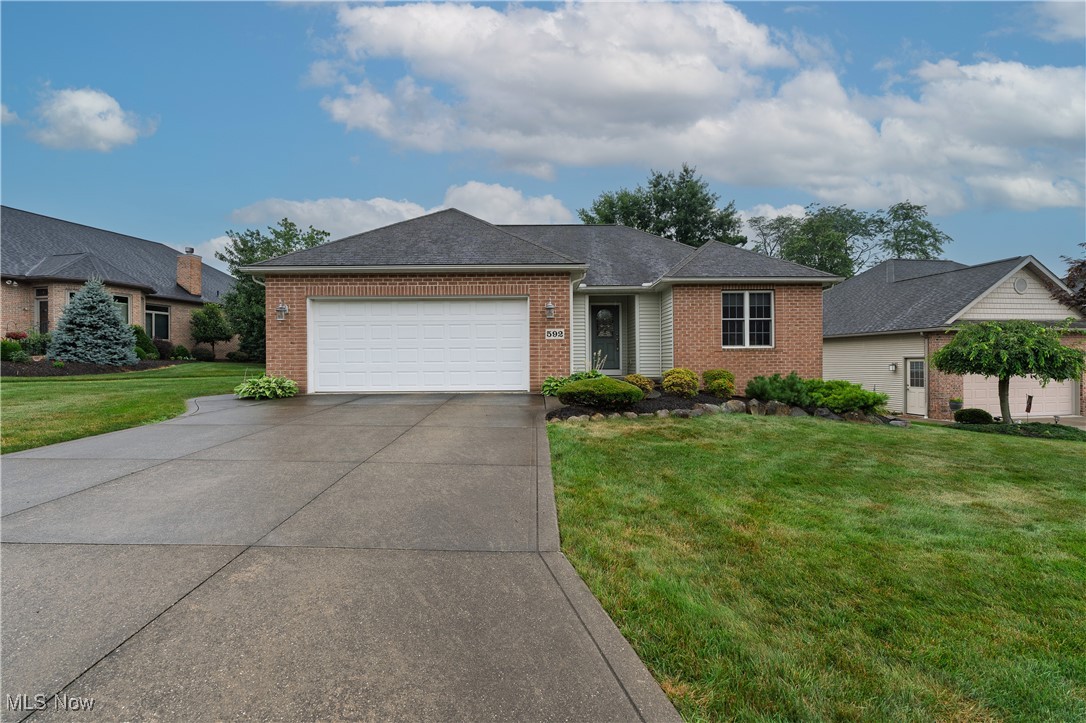 Welcome home to 592 Sonora Drive in Barberton's Austin Estates. Custom built 2 bedroom, 2 bath home features a lovely Great Room with gas fireplace with view of the pond and walking trails. Kitchen has center island, pantry, bayed window eating area, with door that leads out to the patio. Master ensuite w/walk-in closet and stand-alone shower. 2nd Bedroom close to the second full bath w/tub/shower. 1st floor laundry. 2 car attached garage w/drain, man door and hot& cold water. Full basement with glass block windows, steel beam construction. Furnace and Air conditioner 2024; Hot water tank-2020, washer and dryer-2017. House was used as a summer home for the first 10 years and the last ten years has been gently used by one person. Just like new inside. No more mowing or snow shoveling with the low monthly HOA fee. Enjoy the 3 parking lots, walking trails and pond.