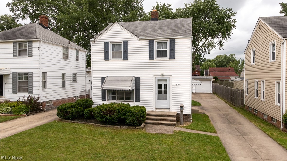 12608 Thraves Ave Garfield Heights is a beautiful Colonial home that will meet all your needs. This 3 Bedroom 1 & a 1/2 bath home has wood grain floors throughout the 1st &2nd floor installed 2018. The bedrooms are all carpeted & have natural light, one bedroom ample sized for a king bed. The light & airy feel of this home & size of the yard are great for entertaining. Kitchen has a great layout for cooking & opens to the wonderful Dining Room with large window area which then opens to a HUGE Living Room with all kinds of ways to arrange your furniture, even room enough for an office desk area near the stairs. With a bonus room in the basement next to the laundry room & half bath it gives this home the extra room needed for whatever you want! Garage to protect your vehicles and grill in your back yard with plenty of room to entertain! Updated look throughout & includes new furnace in 2018, fresh paint, lovely neighborhood feel, friendly atmosphere, close proximity to both public and p