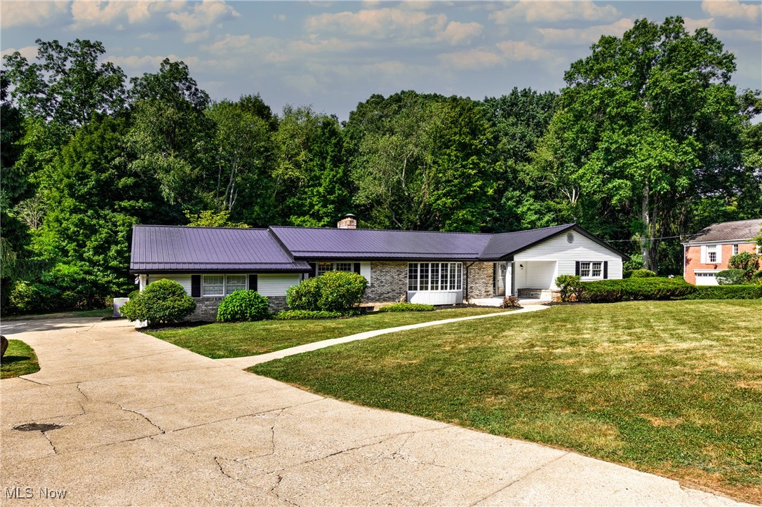 Welcome to luxury living redefined! This impeccably redesigned and fully renovated ranch-style home, that is nestled adjacent to one of the area's most exclusive Country Clubs. This expansive residence seamlessly blends modern sophistication with timeless design, offering an unparalleled lifestyle of comfort, privacy, and elegance. Boasting a well planned layout, this home features 4 bedrooms and 2 full bathrooms across 3,176 square feet of refined living space. Every detail has been thoughtfully curated — from the all new flooring and custom millwork to the designer lighting and high-end finishes throughout. The chef’s kitchen is a true showpiece, outfitted with premium stainless steel appliances, quartz countertops, an oversized island, custom cabinetry and a custom designed kitchenette. The kitchen connects effortlessly with the spacious dining and living areas, ideal for entertaining or relaxing with family. The large luxurious primary-suite offers a spa-inspired ensuite and a large walk-in closet. The additional bedrooms provide ample space for family, guests, or a home office. As you step outside through the all season Florida room, to a private backyard oasis, complete with a concrete patio, built-in fireplace, and tranquil privacy. This fantastic property is a short walk or golf-cart ride to one of the areas best Country Clubs, that boasts a meticulous and challenging 18 hole course, fine dining, swimming, tennis and pickleball. This home offers the perfect balance of modern comfort and timeless elegance in an unbeatable location. Call today to schedule your private showing.