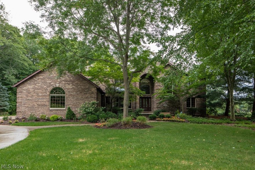 Welcome to 1229 River Woods Dr.! Nestled in the highly coveted River Woods subdivision, this massive solid brick colonial is situated on a private wooded 2.5 acres. Heading in through the front door, a grand entrance awaits featuring the two story foyer, handsome stairwell/balcony, and gleaming hardwood flooring which sprawls throughout the first level. The massive two story great room that is ideal for entertaining leads into the stately study, alongside a peaceful office. For a formal gathering, the dining room is an optimal space. The custom kitchen provides an abundance of solid cabinetry/granite countertop space, and an eat-in area w/ bay window overlooking majestic backyard views. Just off of the kitchen is a cozy, yet large family room, encased with windows filling the space gently w/ natural light. Heading upstairs you will find 4 bedrooms, bonus room. The owner's suite features a large en-suite, balcony views of both the backyard & great room. Serenity is provided in the flat