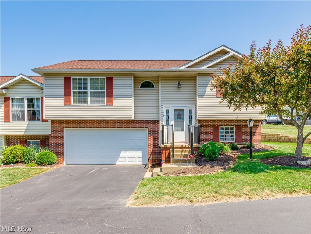 Sharp Munroe Falls condo in River Ridge development. This end unit has been beautifully maintained with many updates. A nice open and bright floor plan with a vaulted ceiling . A spacious living and dining area flows into the kitchen or through the sliding doors to the deck porch. Two spacious bedrooms and two full baths including a private bath in the main bedroom. Lower level offers a possible third bedroom , office, game room or family room. It also includes a laundry room, 1/2 bath and access to the deep, oversized attached two car garage. This unit is nicely landscaped with a decorative brick wall creating a semi private yard to enjoy. Very clean and maintained in excellent condition with these updates since 2015: roof, skylight, carpet, all flooring,most appliances, water heater, insulated garage door, garage door opener with wifi capability, blinds, plus all three bathrooms redone too! Walking distance to hike and bike trails plus many parks are in the area. This is a l