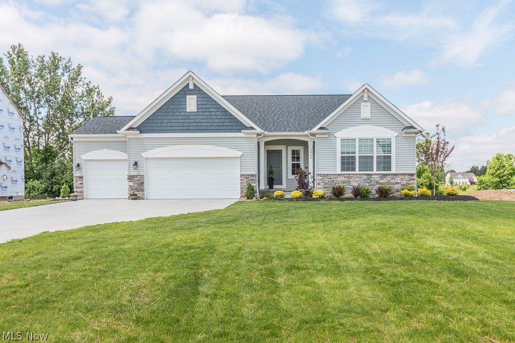 Why go thru the stress of building when you buy this not even 1 year young Ranch home that has 3 bedrooms, 3 car garage, open layout, upgrades throughout and a private and professionally landscaped lot that backs up to a nature preserve and a lake! Walk up to the covered front porch and enter in the front door to a view of the spacious foyer w/ large closet space & hand-scraped wood floors that flow throughout most of the main floor. Walk into the eat-in Kitchen that features granite tops w/ tile backsplash, stainless steel appliances, crown molding, pantry, a ton of cabinet space that's great for storage & a large sit at island w/ under-mount sink. The Kitchen is completely open to the Dining area & the Great Room that has a beautiful corner gas fireplace. The back of the house has a great view of the private covered porch and backyard w/ huge windows great for natural light. The Master Bedroom has vaulted ceilings, a walk-in closet & a private bathroom that features tile floors,