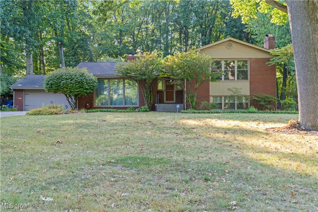 Beautiful 4/5 bedroom Brick & Vinyl Multi Level home on a park-like setting. The foyer opens to a large living room with a beautiful fireplace, the dining room has hardwood floors. The large kitchen features granite countertops, ceramic tiles and all appliances are included. The dinette overlooks the huge Florida room, play room with custom made Louver Shutters. The master bedroom has a master bath off of it and 2 large closets. The second large bedroom has a Jack & Jill bath and a beautiful 2nd fireplace and built in bookshelves. The third bedroom has sliding doors to the upper deck with a Hot tub, overlooking the peaceful wooded backyard. The lower level has a finished Rec room. Tons of closets and space. Huge patio with stamped concrete, heated 2 car garage, all house generator and much more!
