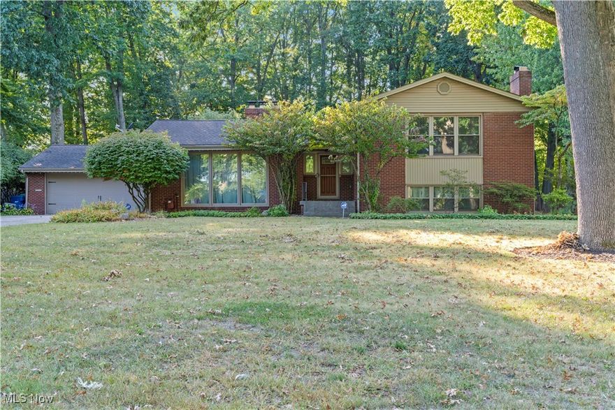 Beautiful 4/5 bedroom Brick & Vinyl Multi Level home on a park-like setting.  The foyer opens to a large living room with a beautiful fireplace, the dining room has hardwood floors.  The large kitchen features granite countertops, ceramic tiles and all appliances are included.  The dinette overlooks the huge Florida room, play room with custom made Louver Shutters.  The master bedroom has a master bath off of it and 2 large closets.  The second large bedroom has a Jack & Jill bath and a beautiful 2nd fireplace and built in bookshelves.  The third bedroom has sliding doors to the upper deck with a Hot tub, overlooking the peaceful wooded backyard.  The lower level has a finished Rec room.  Tons of closets and space.  Huge patio with stamped concrete, heated 2 car garage, all house generator and much more!