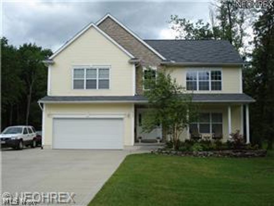 BRING OFFERS!!!!!Possible Short Sale.  Live in the Village within walking distance to stores and school but still have the quiet wooded view from the back patio.  Like new, home has been updated and has new carpet and fresh paint.  This home offers 2210 sq feet above ground with an additional 400+ sq feet in the basement which is ready for your finishing touch. Amenities include 9 ft ceilings throughout. Stone and vinyl exterior with relaxing front porch. Two story foyer and spacious living room/ office with recessed lighting. The family room features a  gas fireplace and is open to the kitchen. Kitchen features Light oak cabinets, breakfast bar and dinette area with sliders to back patio. 1st floor laundry with access to the back yard. Master bedroom suite offers wood floors in bath, jetted tub and his & hers sinks. New High efficiency furnace, security system. Two car garage. A 20 ft wide drive and 14 ft wide boat or RV pad for toys is on the side of garage. Large out building