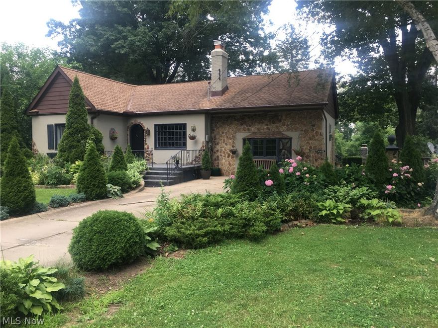 Adorable home that looks like a Gingerbread House! Great location! On almost two acres but in the heart of Fairlawn by the mall, restaurants, retail, and near the expressway. Looking for a home with character, charm, and could feel like your own! The living room has working fireplace, and very spacious. Two bedrooms and bathroom off the living room area.  An updated charming kitchen with double oven, dishwasher, stove top in the island and wet bar. Tons of storage in the kitchen and throughout the house!! The room off the kitchen could be used a formal dining area or a family room. Sliding glass door of the kitchen leads to deck with outside bar. The side door of the dining, family room area leads to a patio area. The master bedroom is large and has own bathroom on the lower level with laundry, utility room, and a finished room that could be a walk in closet, a sewing room, office, craft room, etc.  There is a car port that can be used as a garage for vehicles. Basically a garage with
