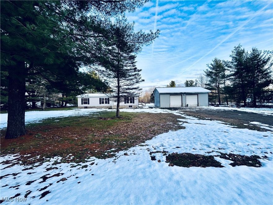 Big lot, big garage, big possibilities. This 3 bedroom 2 bath home serves up space and functionality in all the right ways. If wide-open space and a dream garage are on your wish list, consider it granted! 

Inside, you'll find an open and airy living area with vaulted ceilings that instantly make the home feel spacious and inviting. The heart of the home connects seamlessly to the kitchen where the stove and refrigerator stay. Washer and dryer to also stay making move-in day a breeze. The primary suite is your own private retreat, featuring a full en-suite bathroom and dual closets, offering both comfort and privacy. Two additional bedrooms and another full bath provide plenty of space for family, guests, or a home office. Appreciate the ease of single floor living and enjoy the comfort of central air when those dog-days of Ohio heat roll in. 

Outside, the property shines with a huge detached 32x40 heated garage boasting a 12 foot ceiling, 2 -10x10 garage doors, 50 amp service and a 220 hook up. With over 2 acres on a corner lot there's room to spread out, garden, explore, and enjoy the privacy of country living.