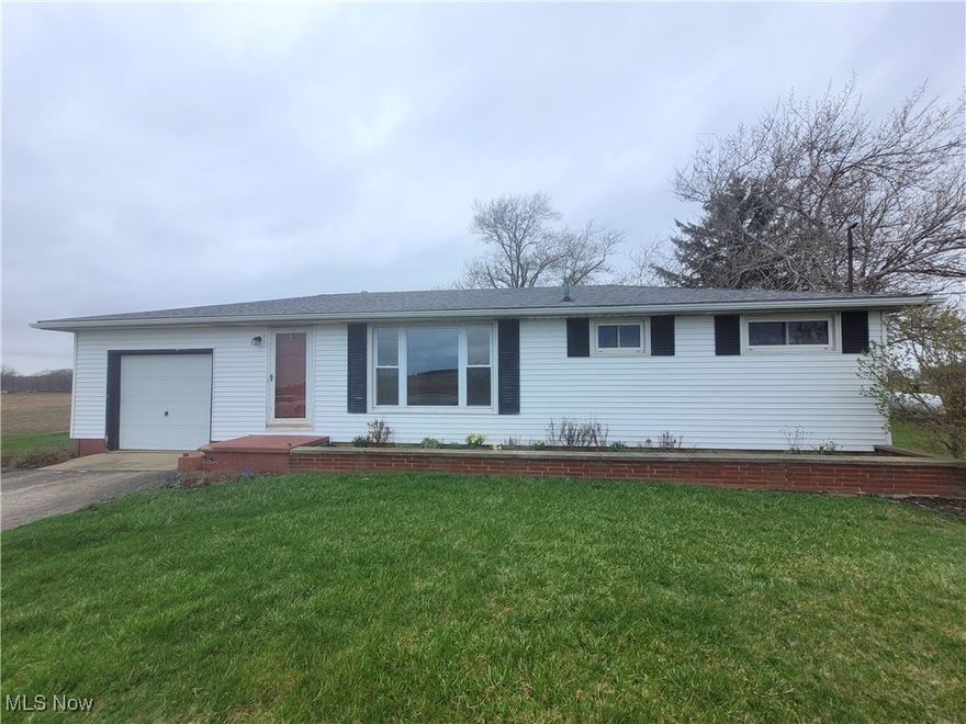 This solid ranch is nestled among farm fields giving you the rural views you may want in your new home. The windows, furnace, central air, hot water tank and basement glass block have all been updated, which will allow you to gradually update the interior to your personal taste without breaking the bank. All 3 bedrooms have hardwood floors and the kitchen has an updated marble look with vinyl tile flooring. The laundry hookups currently have been moved into the 3rd bedroom for 1st floor convenience, but can be easily moved back to the basement if preferred.