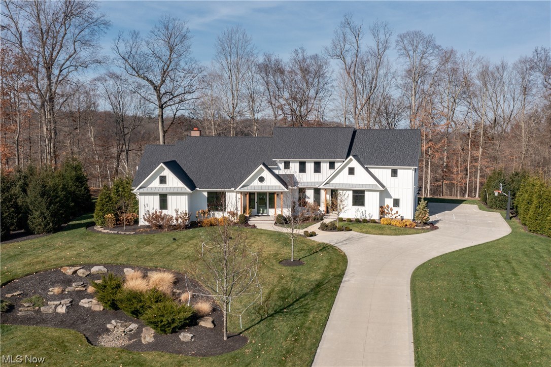 Introducing 30 Addison Lane in Moreland Hills. This extraordinary residence, built by Larry Bloch builders in 2019 and expanded in 2021, offers a truly unparalleled living experience. Situated on a sprawling 2+ acre lot in Chagrin Falls School District, this home is situated perfectly in Chagrin Bluffs. Spanning over 6,000 square feet, the home boasts exquisite contemporary finishes and a breathtaking backyard oasis. No detail was overlooked in creating a forward-thinking and technologically advanced home, including an interior and exterior Wi-Fi 6e network, the latest Lutron smart system, and an expansive heated garage complete with a 240v EV fast charger. The 2021 expansion added 800 square feet, bringing the total bedroom count to five, including the first-floor primary suite. Also in 2021, the lower level was expertly finished to provide additional spaces for entertainment, relaxation, and well-being. It features a remarkable 500 sf home fitness center, theater room, an additional full bath, a gourmet kitchen, game room, a guest room/second office, and a finished walk-in "winter" closet for seasonal clothing storage. With two kitchens, two laundry rooms, 4.5+ bathrooms, and a flex sixth bedroom on the lower level, this home offers unmatched versatility and comfort. One of the standout features of this property is the first-floor primary wing, complete with a dual office, luxurious en-suite bath with steam shower, and an incredible screened sun porch with a fireplace and heated walkway to the whirlpool spa. Throughout the residence, you'll find exquisite design elements and timeless finishes, including wide plank white oak flooring, floor-to-ceiling windows, quartz countertops, and bespoke flooring, light fixtures, and storage systems throughout. Don't miss the opportunity to own this exceptional property that effortlessly combines contemporary elegance, smart home technology, and an idyllic outdoor retreat.