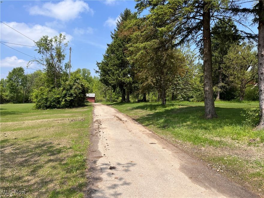 Ready to build.  Driveway is in and utilities are available.  Freshly graded and seeded.  Discover this 11-acre wooded sanctuary in desirable Novelty, Ohio, where nature and opportunity converge. This remarkable property showcases 211 feet of prime frontage along Fairmount Road and extends nearly half a mile northward, offering an ideal canvas for your dream estate. This former horse property contains a five-stall horse barn with good roof.  To the rear, the forested property slopes toward the Chagrin River, which bisects the property with 207 feet of waterfront on both banks. The northern boundary meets the historic inter-urban railway trail, a scenic bridle path, beyond which lies protected land owned by the Western Reserve Land Conservancy—ensuring lasting privacy and preserved natural views. This exceptional setting combines rural tranquility with outstanding accessibility, positioned just minutes from the charming Village of Chagrin Falls, upscale dining, boutique shopping, parks, and convenient access to US-422. This buildable lot presents an excellent opportunity to create a distinguished residence amidst the rolling woodlands of Northeast Ohio's rural countryside.