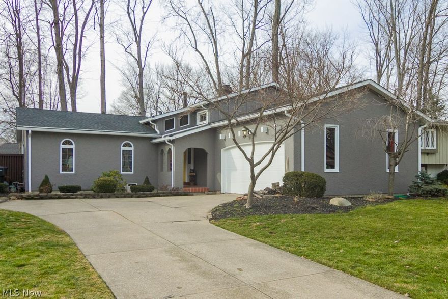 Gorgeous & unique 4 bedroom/2 bath home is loaded with all the bells & whistles complete with many quality finishes! Great curb appeal with a beautifully appointed cedar & stucco exterior was recently painted. Bold foyer with high ceilings & wood floors. Cheerful, modern color palette thru-out!  Spacious living/dining space with crown molding, triple glass sliders to private courtyard style deck. Well appointed kitchen w/ granite counters & white cupboards. Stunning family room w/ custom built-ins and full wall stone fireplace. Finished basement rec. room. The upper level seals the deal with a fabulous 10x11 glamour bath complete w/ skylight, soaking tub/separate shower/double sinks & ceramic tile flooring! Solid wood doors & trim thru out. Some improvement dates to mention; Roof-2010, windows (excluding front) '14, central air '13. Privacy fenced backyard ('09) setting also offers beautiful deck for entertaining! Nestled on a low traffic street near LCCC, 90/conveniences! A great valu