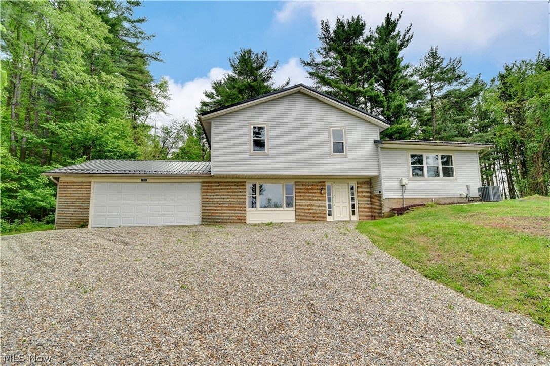 Welcome home to this postcard setting! Great opportunity for a lake home, or Air b'n'b. Three bedrooms, one and half bath split level, sitting on 5.36 of tranquil and treed acres. Open concept living room off of the fabulous eat in kitchen offering an abundance of cabinets and counter space, island, refrigerator, stove and dishwasher. Sliding door off of kitchen is open to the wooden deck, where you can entertain and or sit and enjoy the views of the treed lot and views of Atwood Lake. Three bedrooms, one full bathroom and laundry area on main level. Lower level has a family room, or office, could be bedroom, etc. Basement for storage. Hot water tank (2021), septic system (2019), water softener (2018), metal roof and vinyl siding(2021). Home is fully furnished. Move in ready!