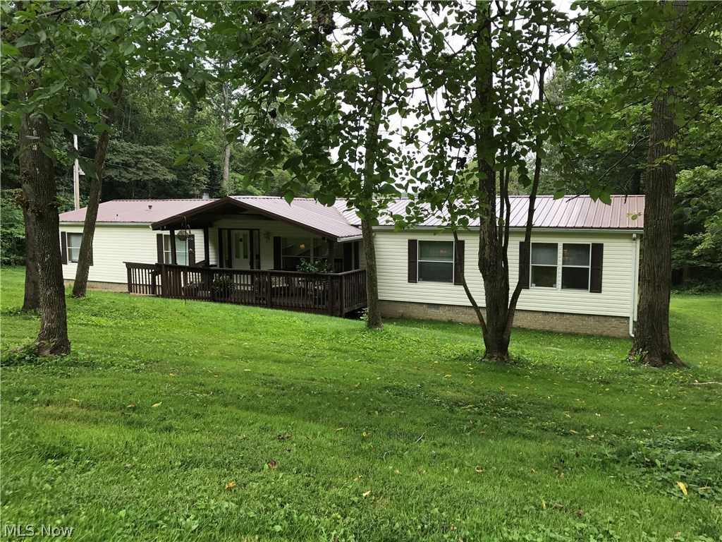 This spacious home offers one floor living in a beautiful country setting just minutes from Atwood Lake!
The formal Living Room is the perfect spot for large gatherings while the cozy Family Room offers an inviting fireplace. The Kitchen has plenty of counter and cabinet space, a breakfast area, additional seating at the island, and is also beside a very roomy formal dining area. The Master Bedroom has a large private bath and a sizable walk-in closet. At the opposite end of the home you'll find two bedrooms, a hall bath, and a laundry room. Directly off the formal living room is also an open office that could very easily be converted into a fourth bedroom. There is a covered front porch, and through the French doors in the kitchen is a large deck overlooking the beautiful back yard and woods beyond. The metal roof was newly installed in 2012. This home is located in Tuscarawas County, Tusky Valley School District, and is approximately 4 miles from Atwood Lake. Seller to split miner