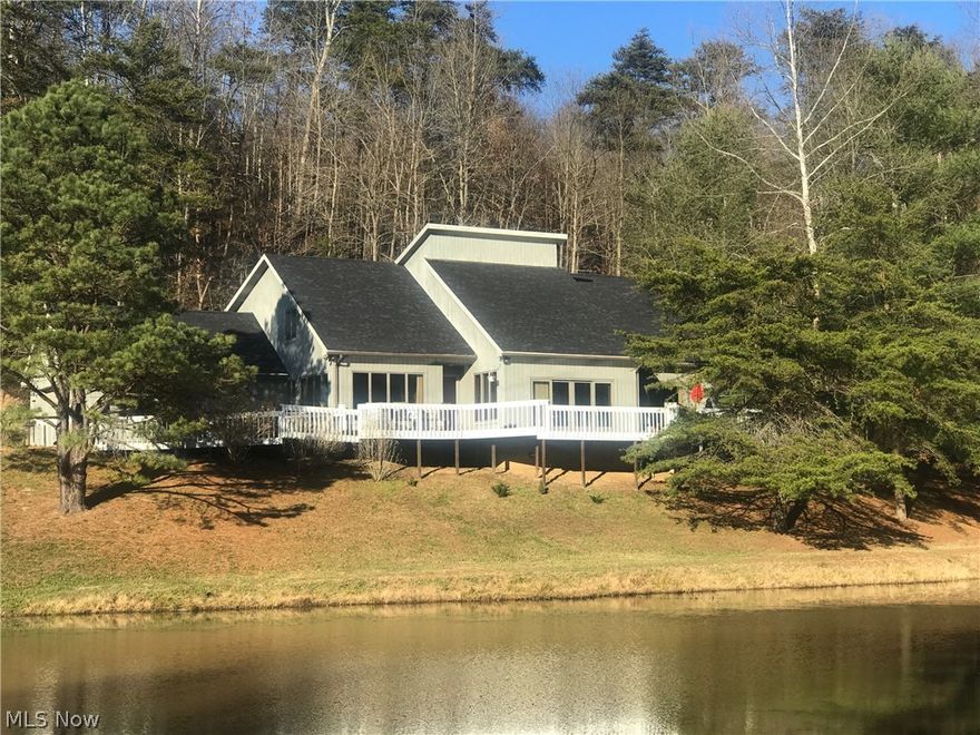 Large open living spaces, overlooking stocked pond, hardwood floors, each bedroom suite contains it's own bath and a large walk-in closet. Huge oversized separate barn or garage with 400 amp electric-could be shop, storage for boat or RV.  Wrap around deck, wooded country views a special property that needs to be seen to visualize potential. 15.92 acres 5 minutes from town.