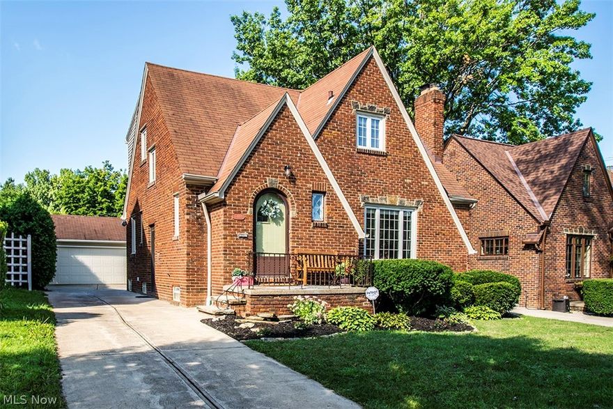 Classic West Park brick bungalow with gorgeous wood flooring throughout. The first level offers a large, bright living room with decorative fireplace, traditional dining room, spacious eat-in kitchen with all appliances, and handy first-floor half bathroom. The second level features two king-sized bedrooms with deep closets and custom blinds, cedar hall closet, nostalgic full bathroom, and pull-down ladder to attic storage. Tasteful knotty-pine rec room, glass block windows, abundant storage, pleasant laundry area with washer/dryer included. Neutral décor and newer windows. Two-car garage, newer driveway, inviting patio and private yard. A must see!