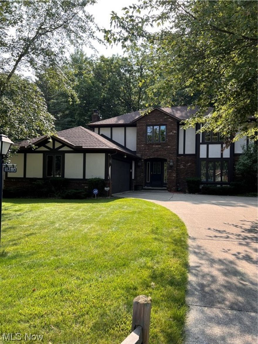 Looking for a great house in a very desirable area? This is it! Looking for a home with land? This is it! Big Tudor Colonial has 3 large bedrooms, 3 full bathrooms, a 2-car attached garage and sits on 2.8 wooded acres. Kitchen key features include beautiful hardwood floors, granite countertops, brand-new stove and fridge and a large eat-in dinette area. First floor includes laundry room and full bathroom. Upstairs you will find 3 large bedrooms with spacious closets and 2 full baths. The living and dining rooms feature custom blinds and a built-in bookshelf. Family room boasts an Lopi fireplace and leads to the three-season enclosed sunroom. Outside features a new privacy fence, gutter guards and a 22x14 two-story Amish built barn. Walk the property and see Chippewa creek meandering through the woods. It flows to the Cuyahoga National Park into the Cuyahoga River. Close to shopping, YMCA and library. Minutes from I-77 and I-71. Top notch school system. AC/furnace 2021.