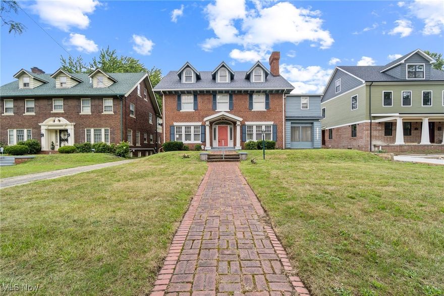 Discover this stunning historic center hall Colonial home in the sought-after Wade Park neighborhood, blending timeless charm with modern updates. The home features original stained glass windows, elegant wainscoting, and classic woodwork that preserve its historic character. Enter through a grand center hall with a wide staircase and stained glass on the first landing. To the right is a formal living room adjoining a sunroom, ideal for relaxing or as a home office/bonus room. To the left, a formal dining room with original wainscoting leads to a butler’s pantry and large, updated kitchen—perfect for entertaining. A stylish half bath is located on the main floor. Upstairs, find six spacious bedrooms, including dual primary suites sharing an en suite bathroom and an additional sunroom. Two other bedrooms share a hall bath. The third floor offers two more bedrooms, a sitting room, and a full bath—great for guests or creative use. Updated electrical, furnace, kitchen, and baths provide modern comfort while maintaining historic appeal. Located within a short distance of University Circle’s cultural and educational institutions, with quick access to I-90 and Greater Cleveland/Cuyahoga County, this home offers city convenience and neighborhood tranquility.