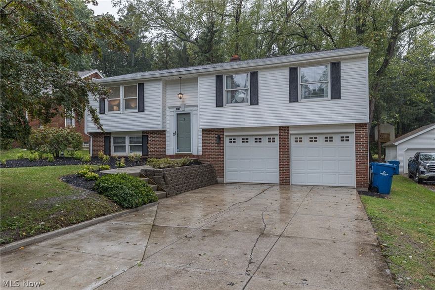 Welcome Home to 5812 Elmhurst Road, a 4 bedroom, 2.5 bath Bi-level featuring over 1,600 sqft. of living space with a two car attached garage; situated near the heart of North Olmsted, quick interstate access, Bradley Woods Reservation, shopping, schools & restaurants! The exterior boasts lush landscaping and takes you to the inviting front entry. You will appreciate the fresh neutral paint, updated light fixtures, new plush carpet & new LVT flooring found throughout most of the home! Lovely living room and conjoined dining room, the perfect space for easy entertaining. The kitchen showcases ample cabinetry, new LVT floors, included stainless appliances & sliding door leading to the spacious deck. Master suite w/ plenty of closet space & a private full bath. 2 more guest bedrooms & a nicely updated full bath complete the main level. On the lower level you will find a spacious family room, 4th bedroom, 1/2 bath & laundry/storage room w/ access to the two-car garage. Nice park-like yard t