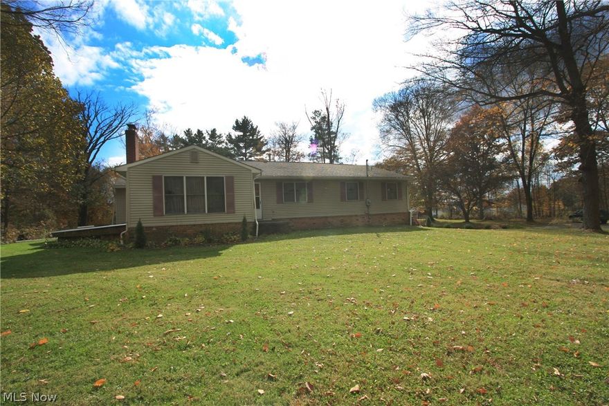 Awesome 4 BEDROOM RANCH home in UNITED LOCAL SCHOOLS. This home sits on nearly 6 acres in a park like setting. Plenty of privacy with a partially wooded lot and a huge composite deck to sit out and enjoy the view.  This home is larger than it looks with 4 large bedrooms a wonderful living room with stone fireplace and a huge dining room which opens to the kitchen. Kitchen features updated laminate flooring, nice oak cabinetry and an eat in bar area. There is a 27 x 14 Sunroom which opens to the deck and also has a wonderful view. First floor Laundry. Some highlights of this home are solid raised panel doors and beautiful new oak trim and baseboards throughout. Hallways are extra wide.  The full bathroom has new flooring and double vanity sinks. Home has large closets and lot's of storage. The lower level has lot's of possibilities with a large rec room featuring a brick fireplace. There is also a full bath in the lower level along with a huge mud room and storage areas. Updates include