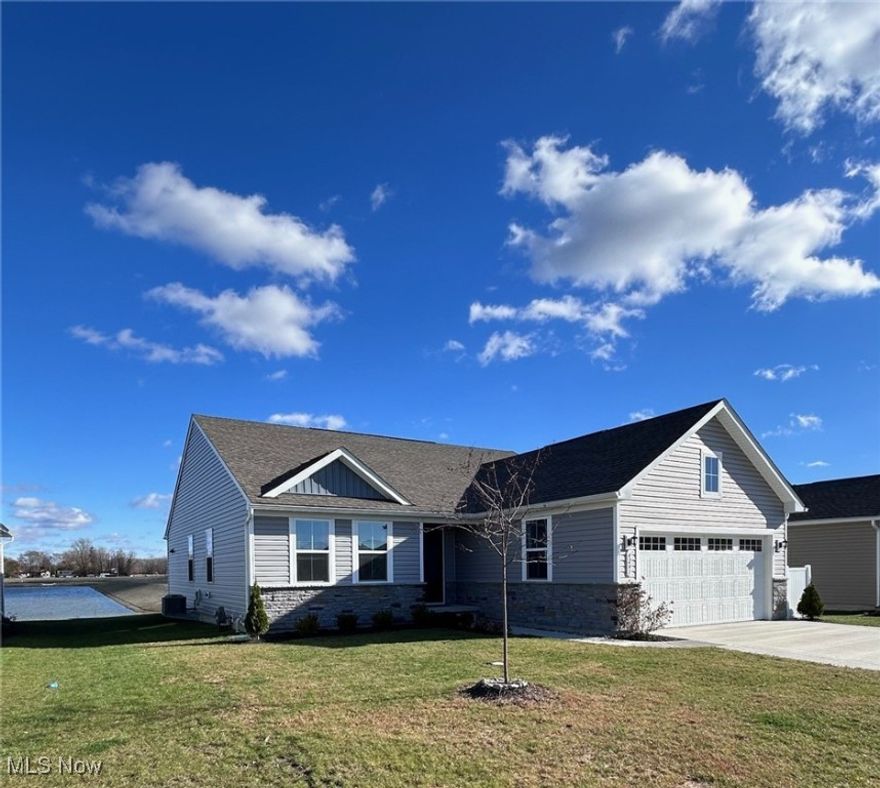 Why wait to build? This 2 year old Hidden Village Ranch has many upgrades already in place !!  With thoughtful enhancements inside and out, this Grand Cayman model offers exceptional value!  Some features include reinforced flooring throughout the entire house, ceiling fans, window blinds and upgraded cabinet hardware. A premium Larson storm door provides durability and curb appeal. You'll love the open concept design and custom details. There are plenty of windows that offer natural light and the neutral decor makes this home move-in-ready.  The kitchen features granite countertops and plenty of cupboards. Outside you'll find expanded side driveway extensions for extra parking and a neatly designed garbage can fence keeps things clean and organized. The sliding doors off the kitchen lead to a covered porch that overlooks a tranquil pond.  This home is perfect for entertaining.  Other features include an extra large shower and a full basement with plumbing for another bathroom and a dehumidifier   The stone exterior gives this beauty great curb appeal.  A must see !!! This is a rare opportunity to own a home with quality upgrades already done for you inside and out!!!