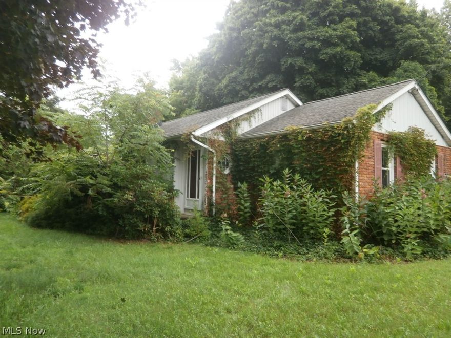 Spacious home in Perry on over a one acre lot. Ranch/Split level home with four bedrooms and two bathrooms, full basement with rec room, wood burning fireplace, dining room, attached one car garage and detached two car garage and a deck over looks the backyard.