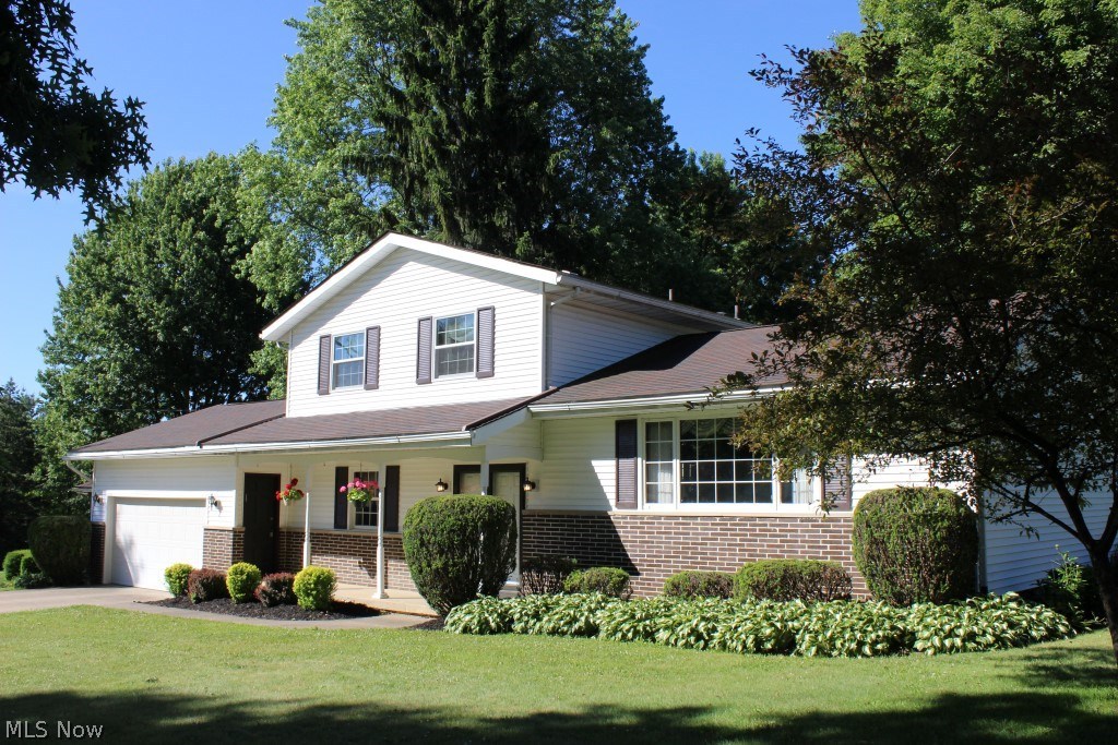 Pretty inside & out 4 level split with 4 bedrooms, 1 full, 2 half baths, approx. 2150SF including rec room* Impeccably maintained & updated* Updates include siding, windows, furnace, A/C, shingles, softener, bathroom, kitchen & appliances* Recent updates include hot water heater, dishwasher, foyer & kitchen ceramic floor, electrical box (approx. 1 yr.)* Light & bright living room opens to formal dining with oak floor & atrium door to deck* Oak kitchen with stainless appliances (refrige, range, microwave & dishwasher), breakfast bar, desk, roll out shelves, ceramic floor, & walk in pantry* 1st floor bedroom with oak floor* Family room with built in book shelves opens to 3 season sun room wrapped with windows (7 sliding doors) leading to patio* Upper level has master bedroom with oak floor, 2 closets & private access to bathroom, plus 2 additional bedrooms with oak floors* Approx. 14 course basement with recreation room, extra shower, & glass block windows* Laundry chute* Covered front p