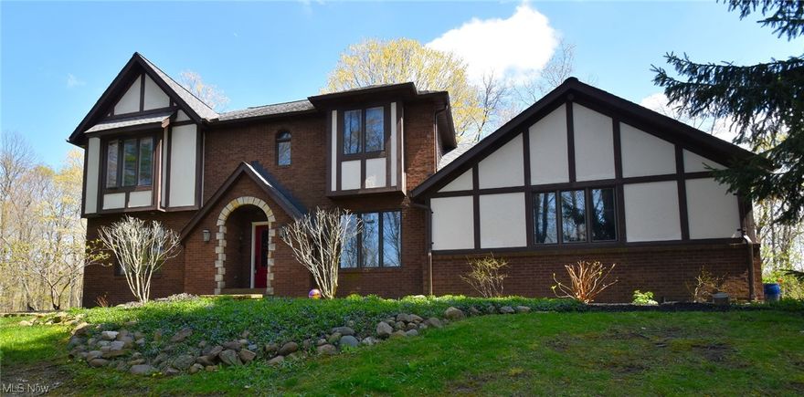 Outstanding four bedroom, two and half bathroom home nestled on over five wooded acres in the desirable West Geauga school district.  Fully updated with high-end finishes throughout. Large, open foyer. Gorgeous, airy open kitchen fully remodeled in 2021 with beautiful Cambria quartz countertops and new double ovens. Oversized dining room with wood burning fireplace opens out to an expansive deck (2019) overlooking your own private, wooded oasis. Upstairs are four bedrooms including a large primary with fully remodeled en suite and large walk-in with custom closet system. Stainmaster carpet throughout the upstairs. Tons of light pours in! Storage everywhere. Large, walk-out basement with finished family/game/play room and full work space. All electric furnace 2022. Air conditioner 2022. New water softener system. Wood burner. Three car garage with 220v 50amp power perfect for EV or generator. Add'l art studio outbuilding. 1 Year Home warranty is included. Please enjoy our attached video